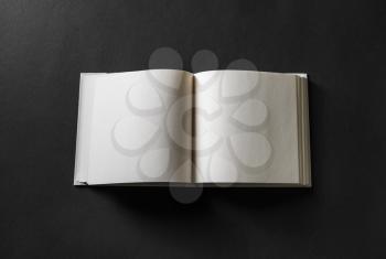 Blank open book on black background. Responsive design mockup.