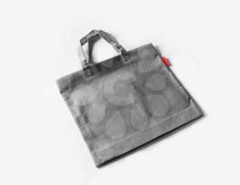 Blank gray shopping canvas bag on white paper background.