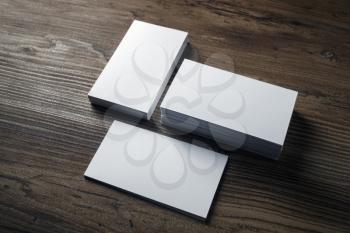 Blank business cards on wood background. Mockup for branding identity.