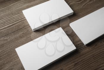 Blank business cards on wood table background. Mockup for branding identity. Studio shot.