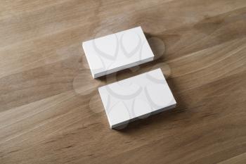 Photo of blank white business cards on wooden background. Template for ID.