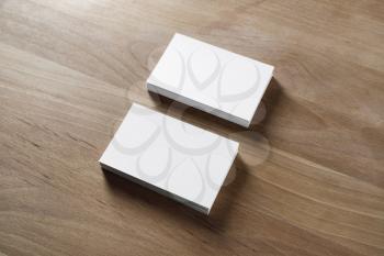 Mockup of two horizontal business cards stacks on wood background.