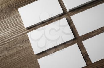 Photo of blank business cards on wood background. For design presentations and portfolios. Top view.