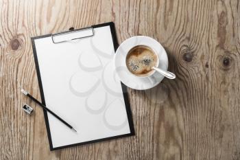 Blank letterhead, clipboard, pencil, sharpener and coffee cup on wooden background. Responsive design template.