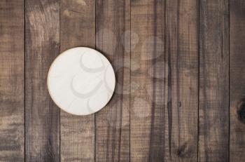 Blank wooden beer coaster on wood table background. Responsive design mockup. Flat lay.