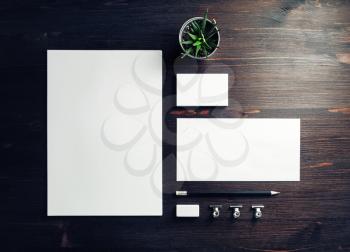 Blank stationery set on wood table background. Corporate identity template. Responsive design mockup. Top view. Flat lay.