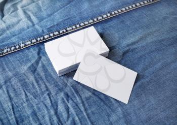 Photo of blank business cards on denim background. Template for ID.