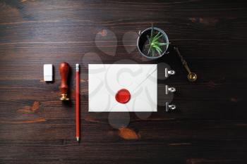 Blank envelope and retro stationery set on wooden background. Flat lay.