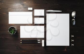 Photo of blank stationery set on wood background. Corporate identity template. Responsive design mockup. Flat lay.