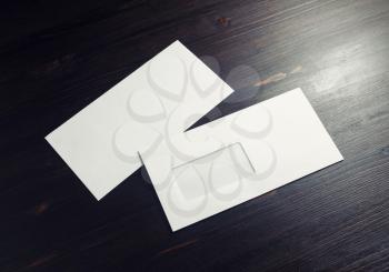 Blank envelopes with window on dark wooden background. Front and back side. Copy space for text.