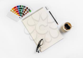 Blank stationery set. Sketchbook, color palette, glasses, coffee cup, pencil and eraser. Flat lay.