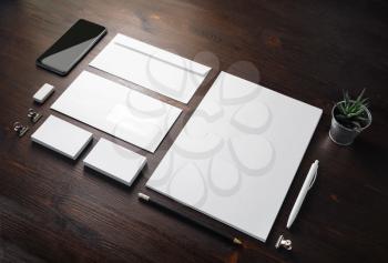 Photo of blank stationery set on wood table background. Corporate identity template. Responsive design mockup.