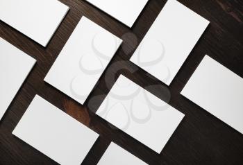 Blank business cards on wood table background. Mockup for branding ID. Flat lay.