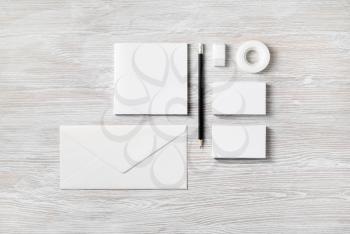 Blank stationery and corporate identity template on light wooden background. Top view. Flat lay.