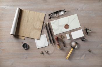 Blank envelope and vintage stationery on wood table background. Flat lay.