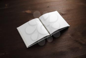 Open book with with blank pages on wooden background.