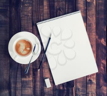 Blank album for drawing, coffee cup, pencil and eraser on wooden background. Blank retro stationery.