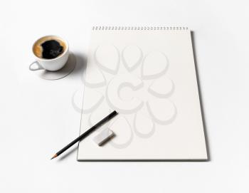 Blank album for drawing, coffee cup, pencil and eraser on paper background.