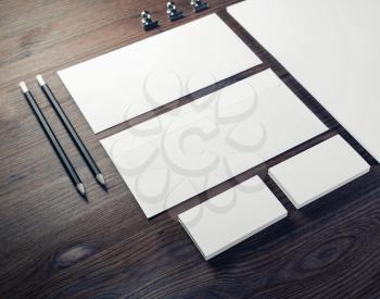 Blank branding mock-up. Blank envelopes, business cards and pencils on wooden background.