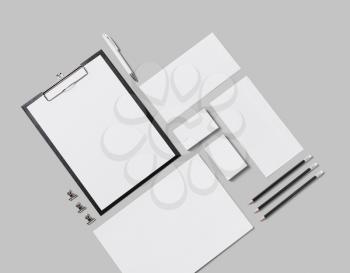 Blank corporate stationery set on gray background. Corporate identity template. Responsive design mockup. Isolated with clipping path. Flat lay.