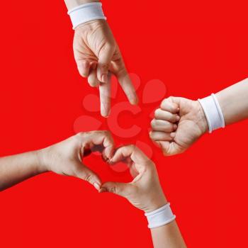 Female hands with white bracelets show gestures on red background. We believe, we can, we will win. Revolution of consciousness in Belarus.