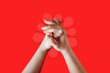 Female hands depict washing on a red background.