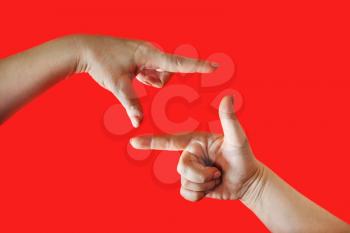 Female hands making frame on red background. Women's palms in the shape of frame.