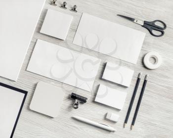 Blank corporate stationery set on light wooden background. Template for branding identity. Top view. Flat lay.
