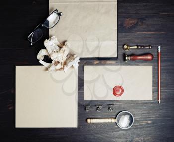 Blank branding identity set on wood table background. Retro stationery template. Top view. Flat lay.