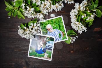 Two square photos with spring flowers on wood table background. Flat lay.