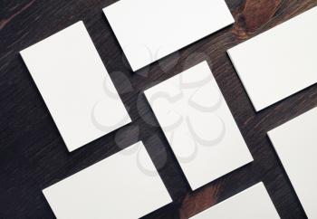 Blank white business cards on wooden background. Mock-up for branding identity. Blank template for design presentations and portfolios. Flat lay.