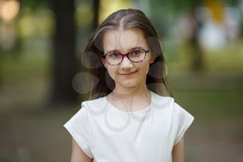 Portrait of child girl with glasses outdoors. Selective focus.