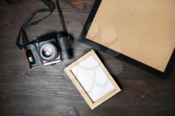 Retro camera and blank photo frames on wooden background. Responsive design mockup. Top view. Flat lay.