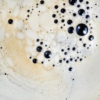 Close-up coffee background. Coffee foam with bubbles. Top view. Flat lay.