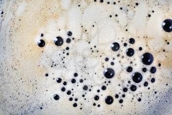 Coffee foam with bubbles background. Close-up coffee texture. Top view. Flat lay.