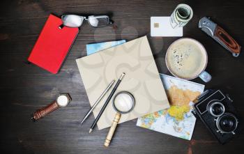 Preparation for travel. Trip vacation accessories and items on wood table background. Flat lay.