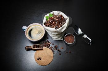 Delicious fresh coffee on black kitchen table background.