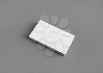 Photo of blank business card on gray paper background. Template for branding identity. Mockup for ID.