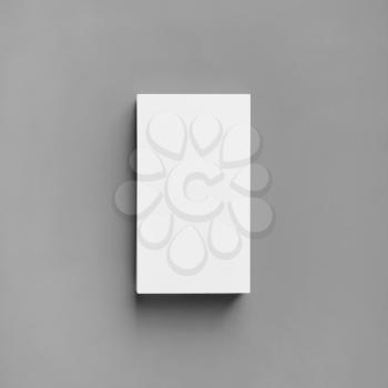 Blank white business card on gray paper background. Mockup for branding identity. Top view. Flat lay.