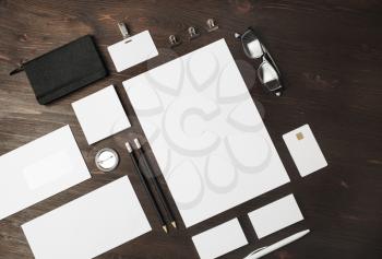 Blank corporate identity template on wood table background. Photo of blank stationery set. Mockup for design presentations and portfolios. Flat lay.