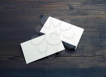 Blank white business cards on wooden background. Mockup for ID. Template for graphic designers portfolios.