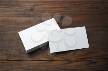 Blank business cards on wood table background. Mockup for branding identity.