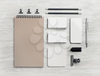 Blank stationery and corporate identity template on light wooden background. Responsive design mockup. Flat lay.