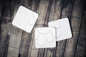 Photo of blank beer coasters on wooden background. Template for placing your design. Flat lay.