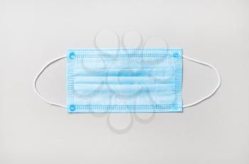 Medical face mask on paper background. Corona virus protection. Top view. Flat lay.