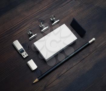 Blank business card, flash drive, pencil and eraser on wood table background. Responsive design mockup.