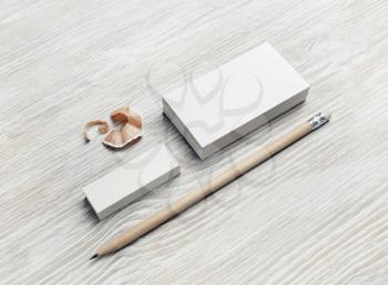 Blank stationery set. Blank business cards, pencil and eraser on light wooden background.