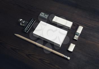 Photo of blank business cards, pencil, eraser and flash drive on wooden background. Blank stationery set.
