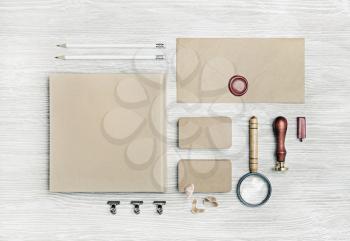 Blank vintage corporate stationery set on light wooden background. Branding mock up. Top view. Flat lay.