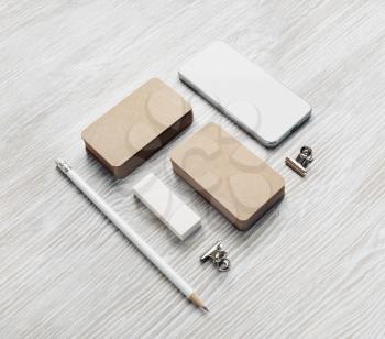 Smartphone and blank stationery set: kraft business cards, pencil and eraser.